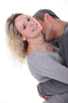 Man kissing wife’s neck