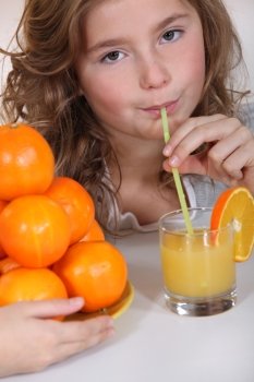 little girl drinking orange juice