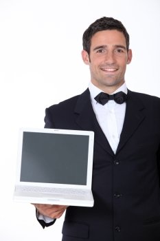 Male waiter holding laptop
