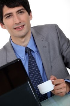 Businessman with laptop and coffee