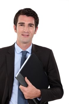 Confident businessman holding folder underarm