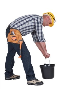 Worker lifting plastic bucket