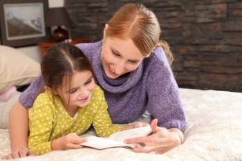 Mother teaching daughter to read