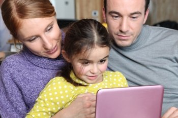 Parents and daughter sat with laptop
