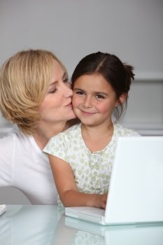 Mother and daughter at laptop computer