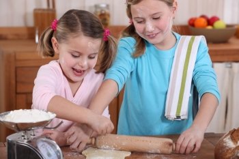 two little girls making pancakes