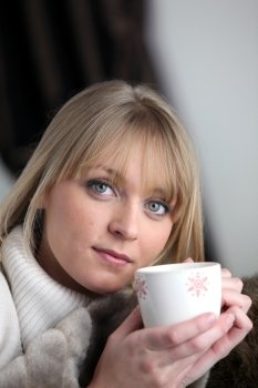 Woman drinking a hot drink