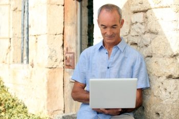 Older man using a laptop computer