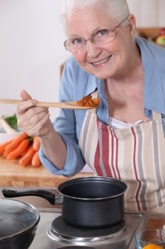 An old lady cooking.