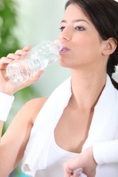 Sportswoman drinking water