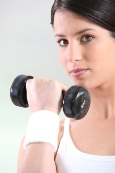 Closeup of a woman using a dumbbell