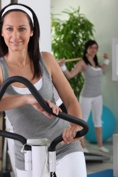 women doing exercise in fitness center