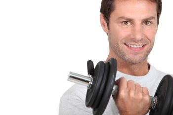 Closeup of smiling man with dumbbell