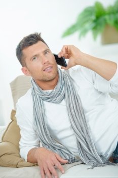 Man on couch on telephone
