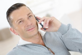 Man smiling whilst on the phone