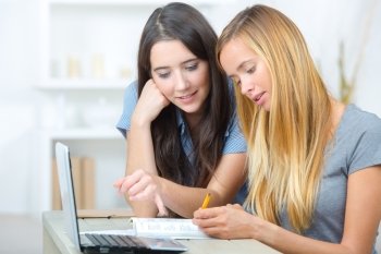 Two female students using a laptop