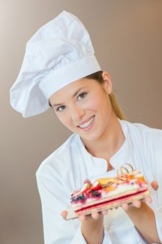 Female bakery chef with a fruit cake