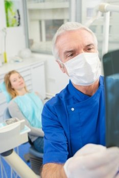 Dentist looking at an x-ray