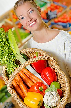Lady holding basket of fresh produce