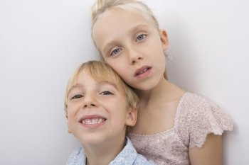 Portrait of brother and sister over gray background