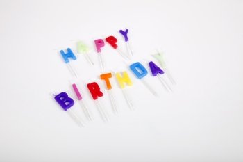 High angle view of birthday candles against white background