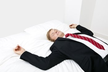 Mid adult businessman sleeping in bed at home