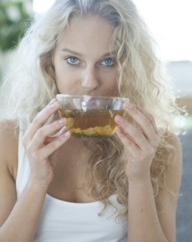 Portrait of young woman drinking herbal tea