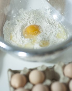 Close-up of raw egg and flour