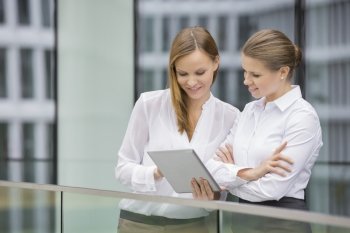 Businesswomen using digital tablet in office