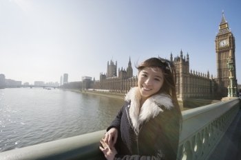 Portrait of happy female tourist visiting Big Ben at London; England; UK