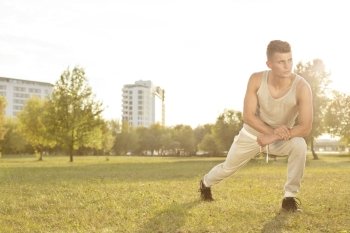 Full length of confident young man exercising in park