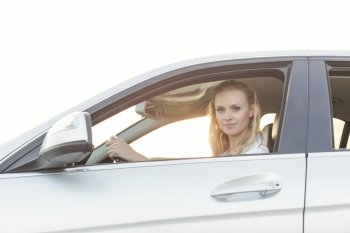 Portrait of beautiful woman driving car