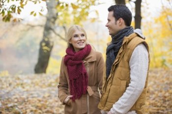 Happy woman looking at man during autumn