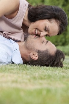 Side view of loving young couple about to kiss in park