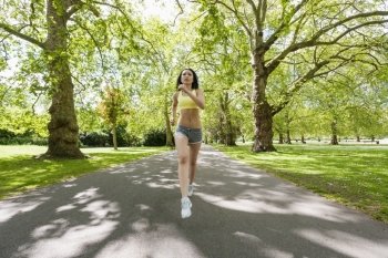 Full length of determined fit woman jogging at park