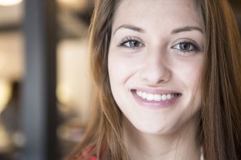 Portrait of confident woman smiling in cafe