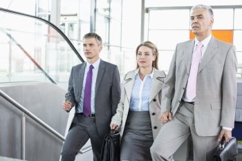 Businesspeople walking up stairs in train station