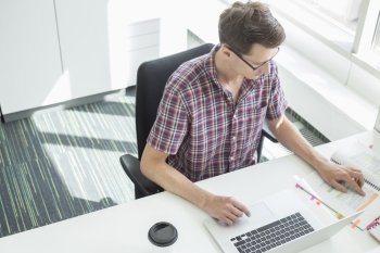 High angle view of creative businessman working at desk in office