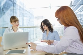 Businesswomen working at table in office