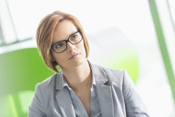 Young businesswoman looking away in office