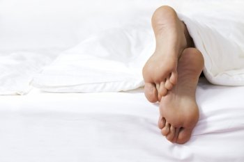 Person’s foot in bed