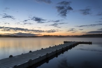 Sunrise landscape of jetty on calm lake