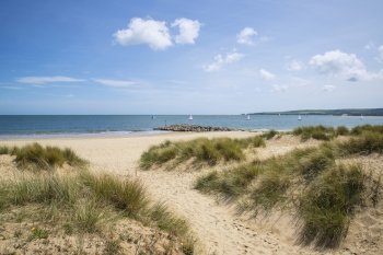 Beautiful sand dunes and beach landscape on sunny Summer day