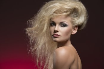 beauty fashion shoot of sexy woman with naked shoulders, charming bushy creative hair-style and cute make-up