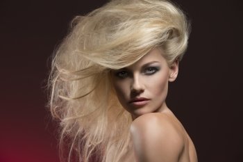 charming beauty portrait of very sexy woman with naked shoulders, bushy creative blonde hair-style and cute make-up