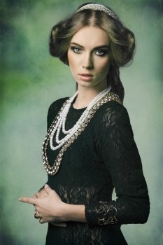 beautiful woman in fantasy portrait with antique princess style, retro hair-style and some brilliant jewellery