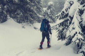 hiker with snowshoes in winter