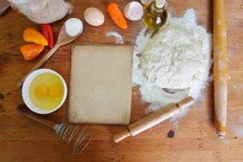 yeast dough, old sheet  and flour on wooden background