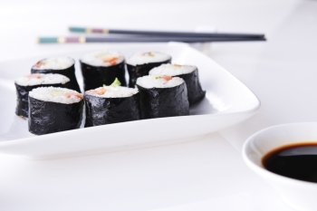 Delicious sushi rolls on white plate