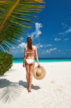 Woman in bikini on a tropical beach at Maldives